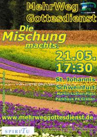 Plakat MehrWegGottesdienst: bunte Blumenwiese mit Wald im Hintergrund